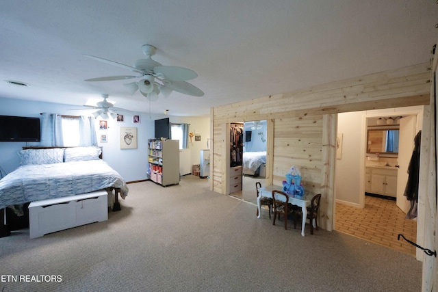 2645 Mountain View Dr, Morristown, TN 37814 - carpeted bedroom featuring wood walls, a ceiling fan, connected bathroom, and baseboards