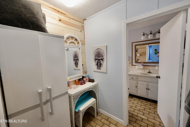 2645 Mountain View Dr, Morristown, TN 37814 - bathroom with brick patterned flooring, vanity, baseboards, and wooden walls