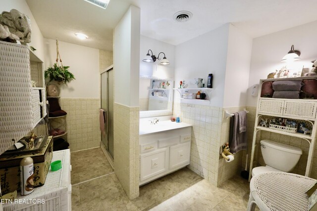 2645 Mountain View Dr, Morristown, TN 37814 - bathroom featuring tile walls, wainscoting, vanity, a shower stall, and tile patterned floors