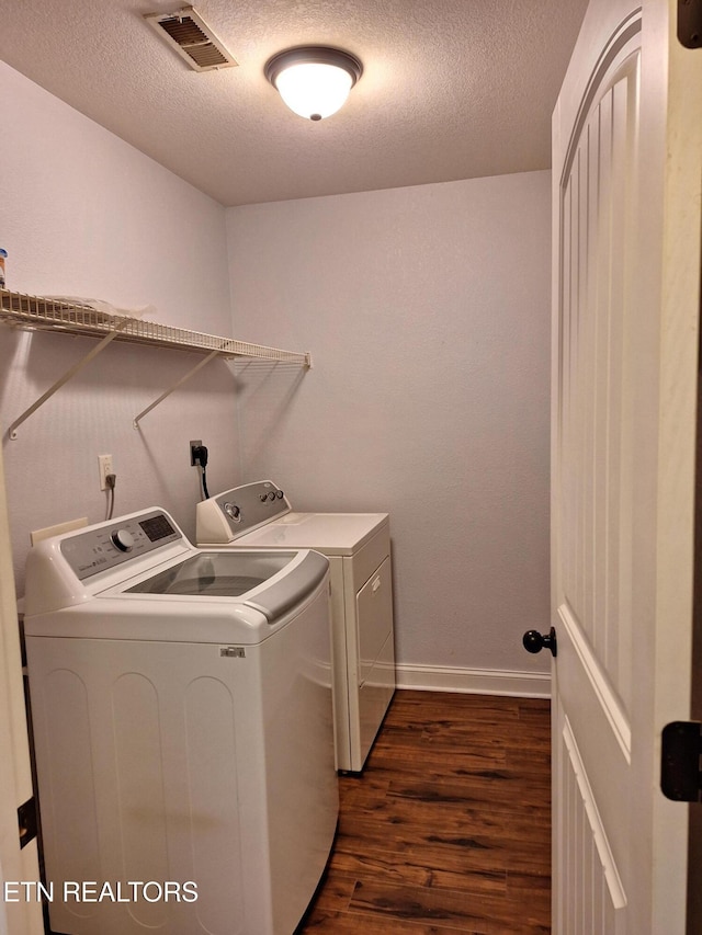 7739 Applecross Rd, Corryton, TN 37721 - laundry room featuring washer and clothes dryer, dark wood-type flooring, a textured ceiling, and baseboards