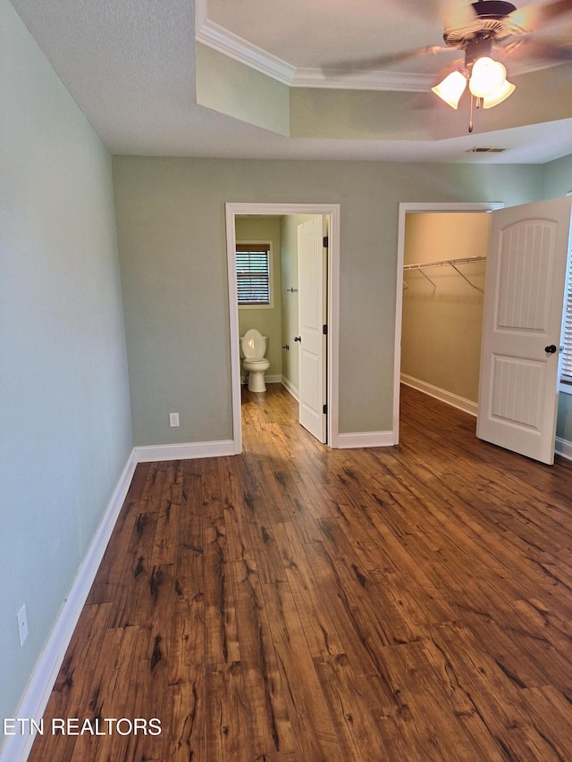 7739 Applecross Rd, Corryton, TN 37721 - unfurnished bedroom with ornamental molding, a walk in closet, wood finished floors, a closet, and baseboards