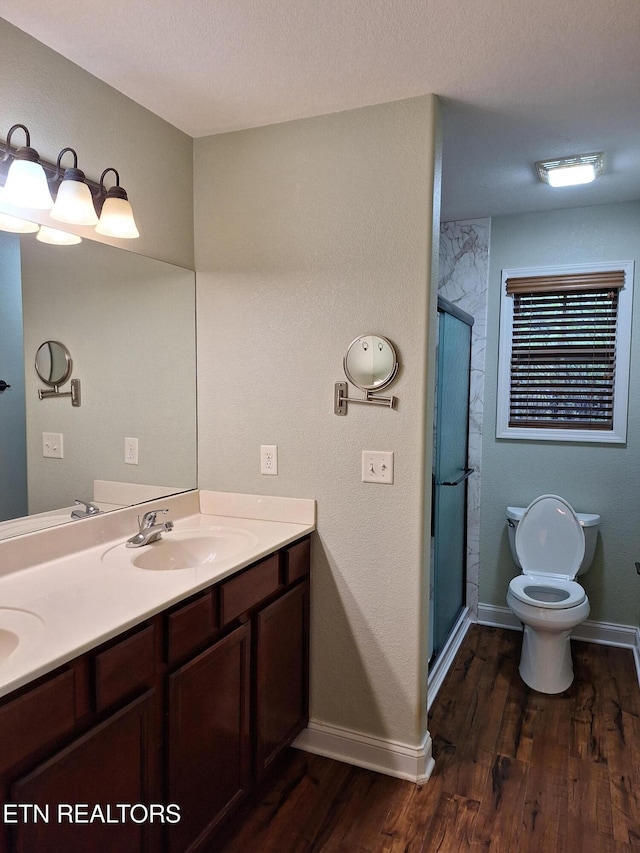 7739 Applecross Rd, Corryton, TN 37721 - bathroom featuring wood finished floors, double vanity, toilet, and a stall shower