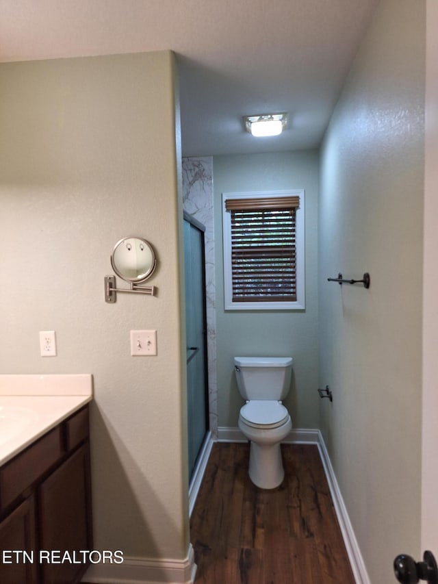 7739 Applecross Rd, Corryton, TN 37721 - full bathroom with toilet, wood finished floors, a shower stall, vanity, and baseboards