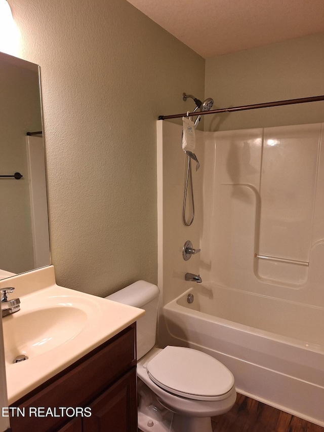 7739 Applecross Rd, Corryton, TN 37721 - bathroom with vanity, a textured wall, toilet, wood finished floors, and tub / shower combination