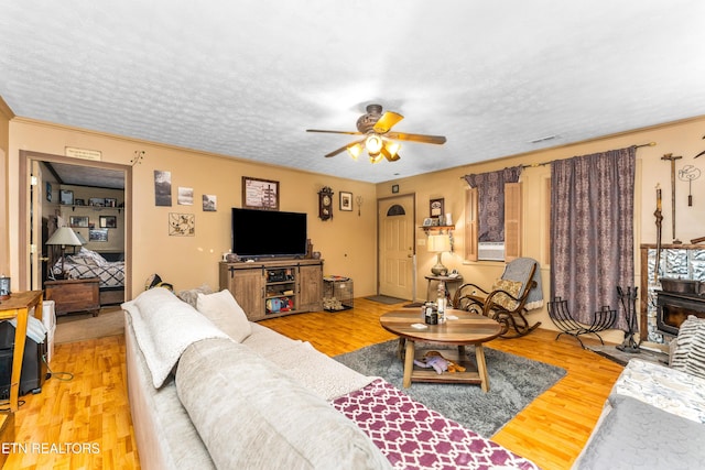 1069 Bryan View Rd, Sevierville, TN 37862 - living area with ceiling fan, a wood stove, light wood-style floors, and ornamental molding