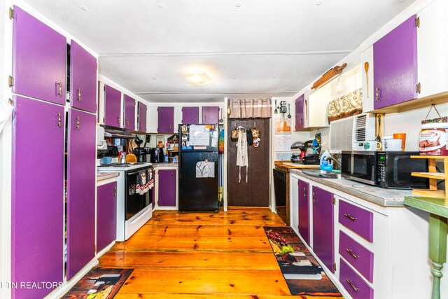 1069 Bryan View Rd, Sevierville, TN 37862 - kitchen with red cabinetry, black appliances, under cabinet range hood, and light wood finished floors