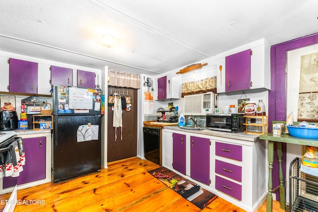 1069 Bryan View Rd, Sevierville, TN 37862 - kitchen with red cabinetry, black appliances, and light wood-style flooring