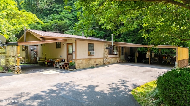 1069 Bryan View Rd, Sevierville, TN 37862 - view of front of property featuring an attached carport, driveway, metal roof, stone siding, and cooling unit