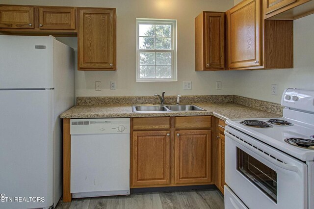1505 Cypress View Ct, Sevierville, TN 37862 - kitchen featuring white appliances, a sink, brown cabinetry, and light countertops
