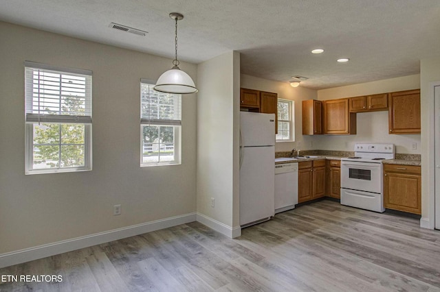 1505 Cypress View Ct, Sevierville, TN 37862 - kitchen featuring white appliances, hanging light fixtures, light wood-type flooring, baseboards, and brown cabinetry