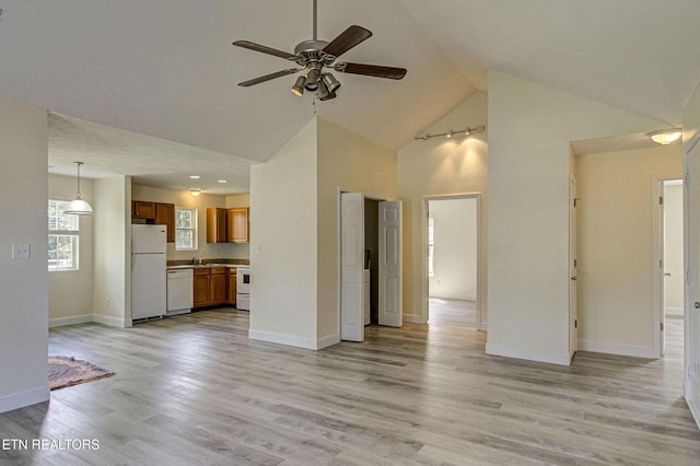 1505 Cypress View Ct, Sevierville, TN 37862 - unfurnished living room featuring high vaulted ceiling, a ceiling fan, baseboards, light wood finished floors, and a sink