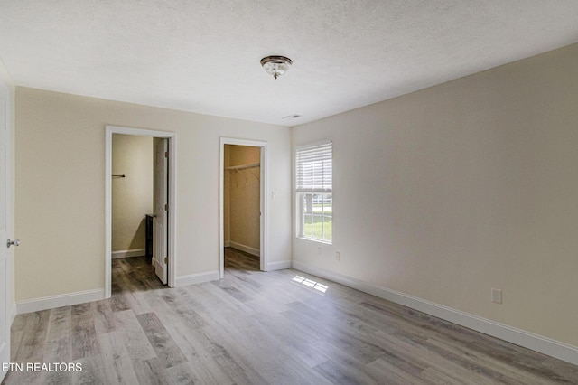 1505 Cypress View Ct, Sevierville, TN 37862 - unfurnished bedroom featuring light wood-style floors, a spacious closet, and baseboards