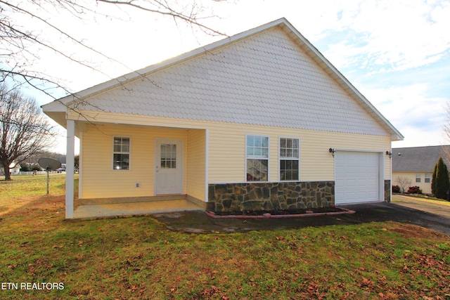 1505 Cypress View Ct, Sevierville, TN 37862 - back of property with an attached garage, driveway, a lawn, and stone siding