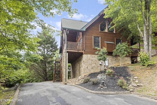 1665 Mountain Lodge Way, Pigeon Forge, TN 37862 - view of side of home featuring stone siding, stairway, a shingled roof, and log veneer siding