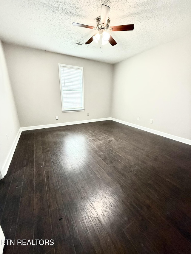 304 Douglas Ave, Knoxville, TN 37921 - spare room featuring ceiling fan, a textured ceiling, dark wood finished floors, and baseboards