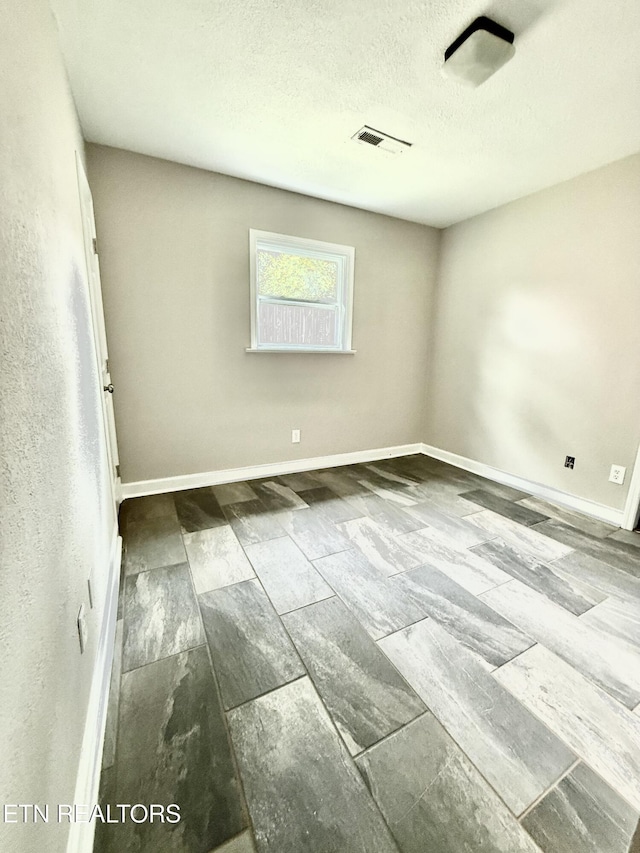 304 Douglas Ave, Knoxville, TN 37921 - spare room featuring baseboards, a textured ceiling, and wood finished floors