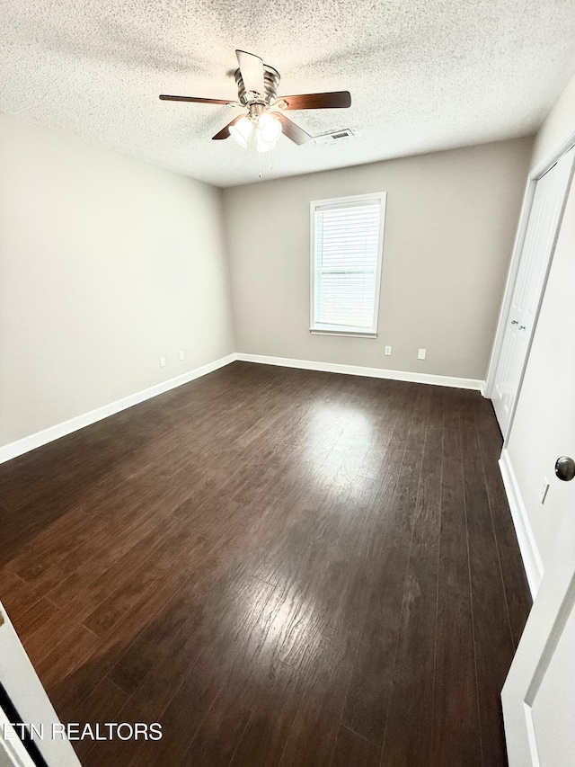 304 Douglas Ave, Knoxville, TN 37921 - unfurnished room with ceiling fan, dark wood finished floors, a textured ceiling, and baseboards