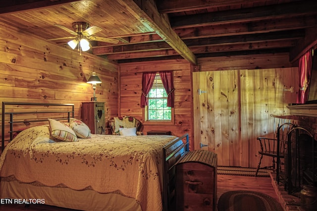 147 Akers Chapel, Jamestown, TN 38556 - bedroom featuring wood finished floors, wooden walls, wooden ceiling with exposed beams, and a fireplace