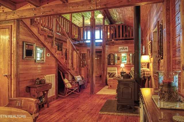 147 Akers Chapel, Jamestown, TN 38556 - staircase featuring wood walls, hardwood / wood-style flooring, a wood stove, beam ceiling, and high vaulted ceiling