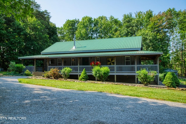 147 Akers Chapel, Jamestown, TN 38556 - farmhouse with covered porch, metal roof, driveway, and a front lawn