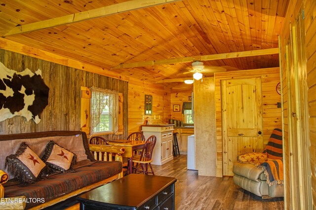 147 Akers Chapel, Jamestown, TN 38556 - living area featuring dark wood finished floors, wood walls, wood ceiling with exposed beams, and a ceiling fan