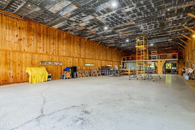 1139 Reagan Valley Rd, Tellico Plains, TN 37385 - miscellaneous room with concrete floors, wooden walls, and a garage