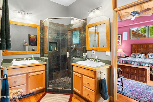 1139 Reagan Valley Rd, Tellico Plains, TN 37385 - full bathroom with two vanities, a shower stall, and wood finished floors