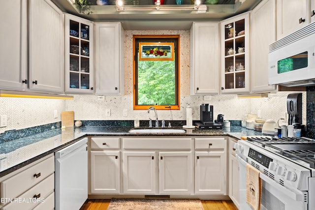 1139 Reagan Valley Rd, Tellico Plains, TN 37385 - kitchen featuring white appliances, dark stone counters, tasteful backsplash, and white cabinets