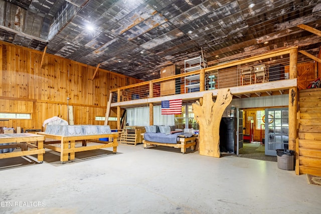 1139 Reagan Valley Rd, Tellico Plains, TN 37385 - bedroom featuring concrete flooring and wood walls