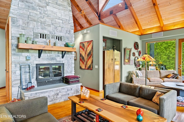 1139 Reagan Valley Rd, Tellico Plains, TN 37385 - living room featuring a wooden ceiling with exposed beams, wood finished floors, a fireplace, and high vaulted ceiling