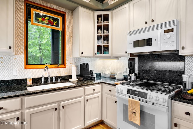 1139 Reagan Valley Rd, Tellico Plains, TN 37385 - kitchen featuring white appliances, white cabinetry, dark stone counters, and glass insert cabinets