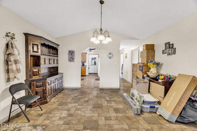 1647 Sams Dr, Dandridge, TN 37725 - dining area with arched walkways, lofted ceiling, stone tile flooring, baseboards, and a chandelier
