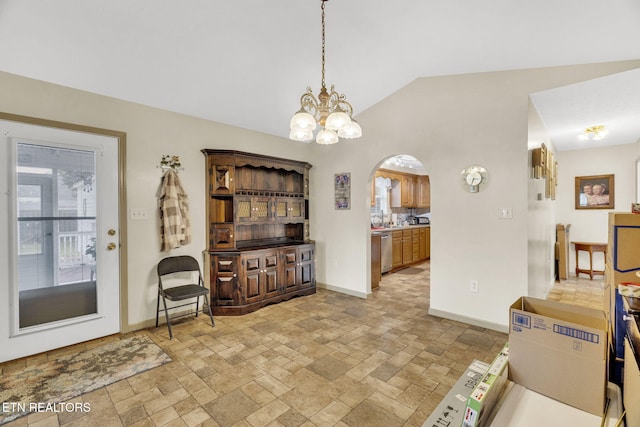 1647 Sams Dr, Dandridge, TN 37725 - dining space featuring baseboards, arched walkways, light stone finish floors, vaulted ceiling, and a chandelier