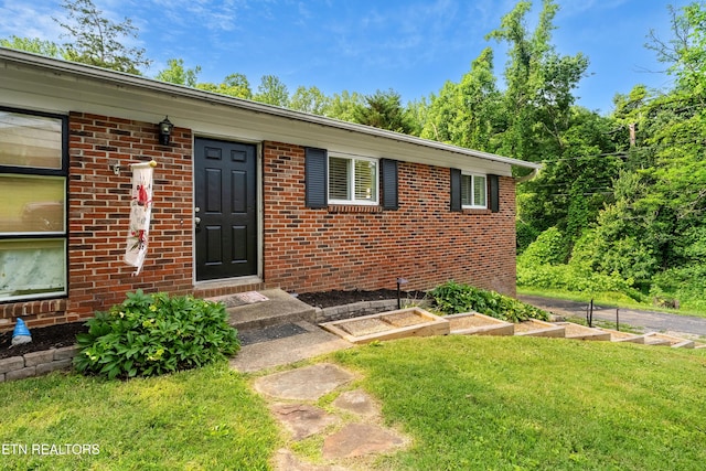 601 S Gallaher View Rd, Knoxville, TN 37919 - view of exterior entry featuring a lawn and brick siding