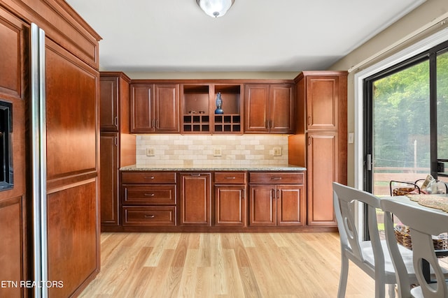 601 S Gallaher View Rd, Knoxville, TN 37919 - kitchen featuring light wood finished floors, decorative backsplash, and light stone countertops