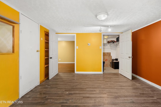 601 S Gallaher View Rd, Knoxville, TN 37919 - unfurnished bedroom with a textured ceiling, dark wood finished floors, baseboards, a closet, and a walk in closet