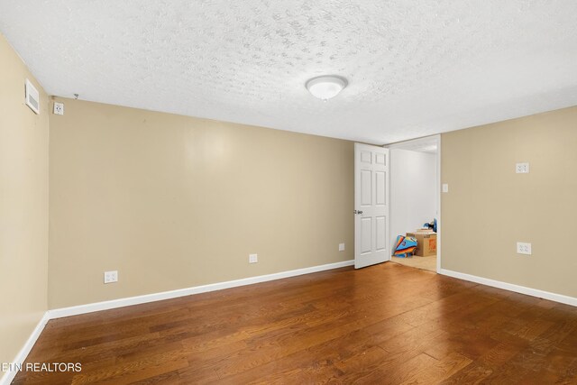 601 S Gallaher View Rd, Knoxville, TN 37919 - finished below grade area with wood finished floors, baseboards, and a textured ceiling