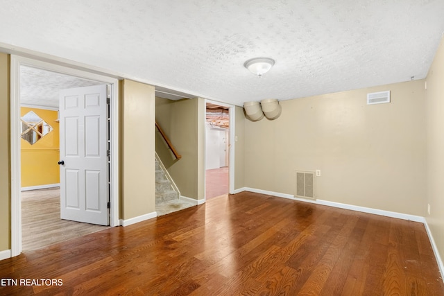 601 S Gallaher View Rd, Knoxville, TN 37919 - finished basement featuring a textured ceiling, wood finished floors, stairs, and baseboards
