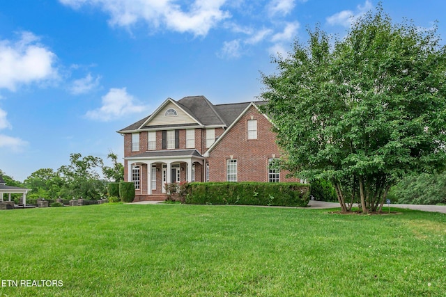 1010 Creek Brook Ln, Seymour, TN 37865 - view of front of house with brick siding, a front lawn, and a porch