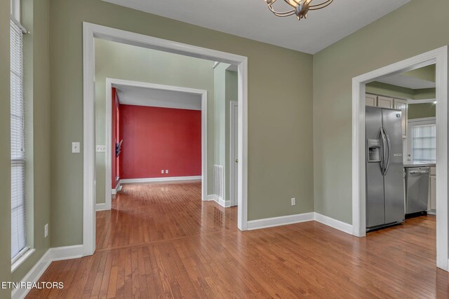 1010 Creek Brook Ln, Seymour, TN 37865 - unfurnished room featuring wood finished floors and a chandelier