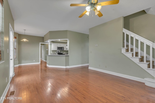 1010 Creek Brook Ln, Seymour, TN 37865 - unfurnished living room with hardwood / wood-style flooring, ceiling fan, and stairway