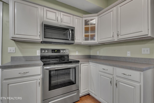 1010 Creek Brook Ln, Seymour, TN 37865 - kitchen with appliances with stainless steel finishes, white cabinets, glass insert cabinets, and light wood finished floors