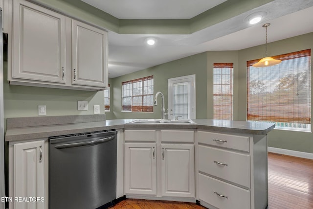 1010 Creek Brook Ln, Seymour, TN 37865 - kitchen featuring stainless steel dishwasher, a peninsula, white cabinets, decorative light fixtures, and light wood finished floors