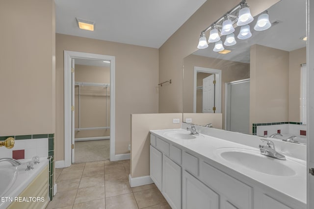 1010 Creek Brook Ln, Seymour, TN 37865 - full bath featuring a shower stall, tile patterned floors, double vanity, a spacious closet, and a garden tub
