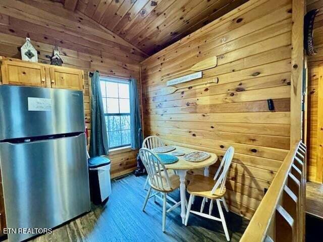 1930 Regans Ridge Way, Sevierville, TN 37876 - dining space featuring lofted ceiling, wood walls, wood ceiling, and wood finished floors