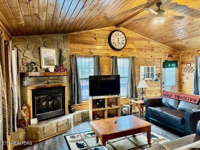 1930 Regans Ridge Way, Sevierville, TN 37876 - living room with vaulted ceiling, wood ceiling, wood walls, ceiling fan, and wood finished floors