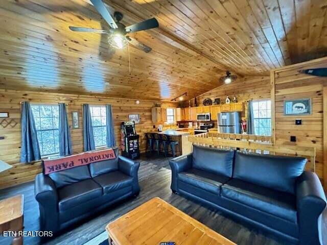 1930 Regans Ridge Way, Sevierville, TN 37876 - living area featuring wooden ceiling, wooden walls, lofted ceiling, a ceiling fan, and dark wood-style floors