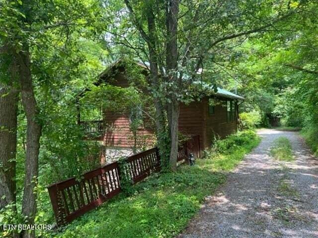 1930 Regans Ridge Way, Sevierville, TN 37876 - view of property exterior with dirt driveway and a wooded view