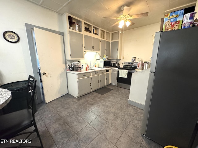 2102 Harvey St, Knoxville, TN 37917 - kitchen with appliances with stainless steel finishes, ceiling fan, a sink, dark tile patterned floors, and gray cabinets