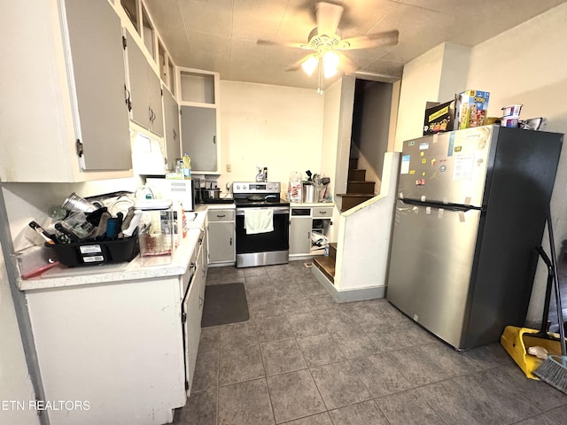 2102 Harvey St, Knoxville, TN 37917 - kitchen featuring stainless steel appliances, ceiling fan, light countertops, and dark tile patterned floors